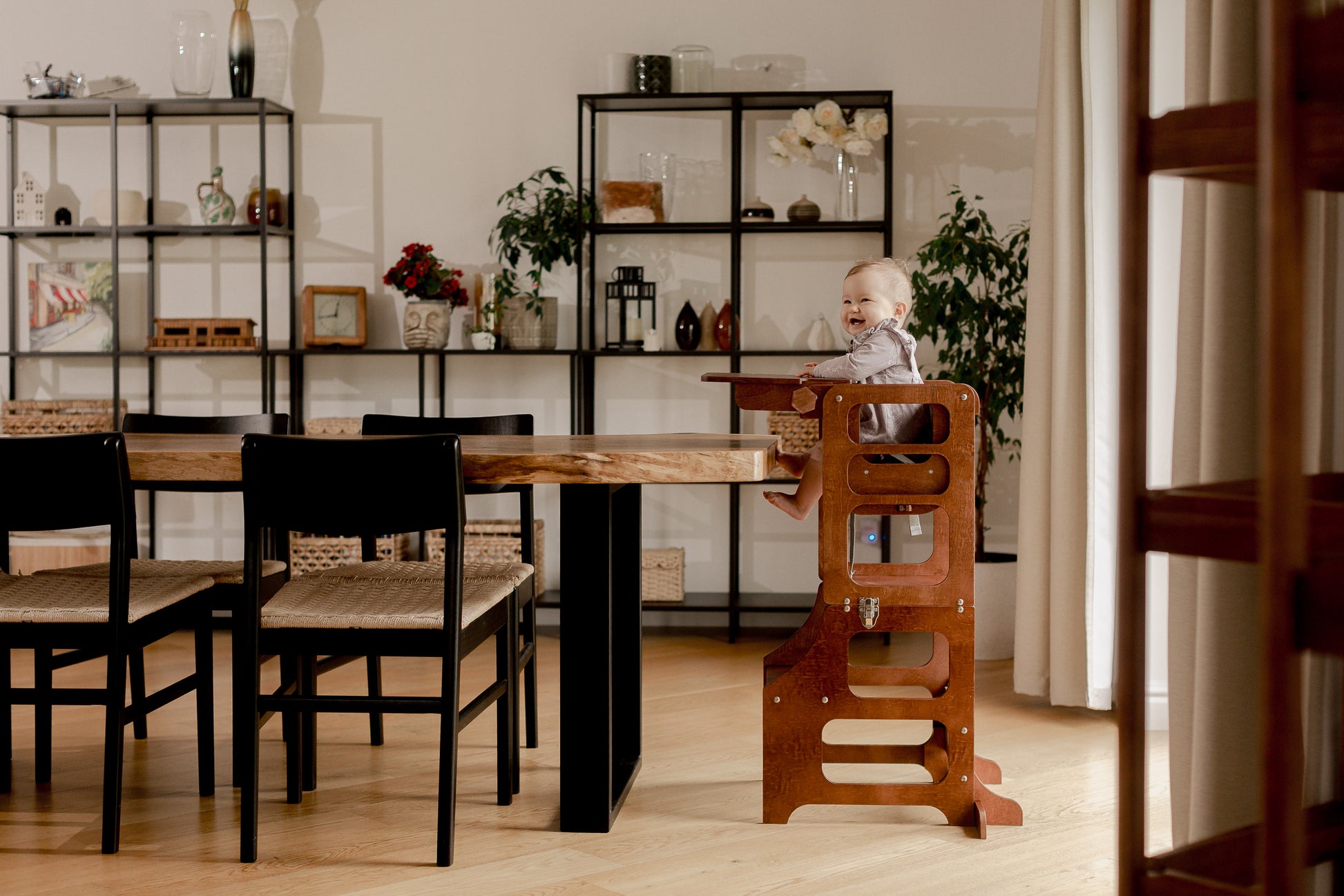 Happy toddler in a Mid Century Modern Foldable Kitchen Tower with a High Chair for a Toddler