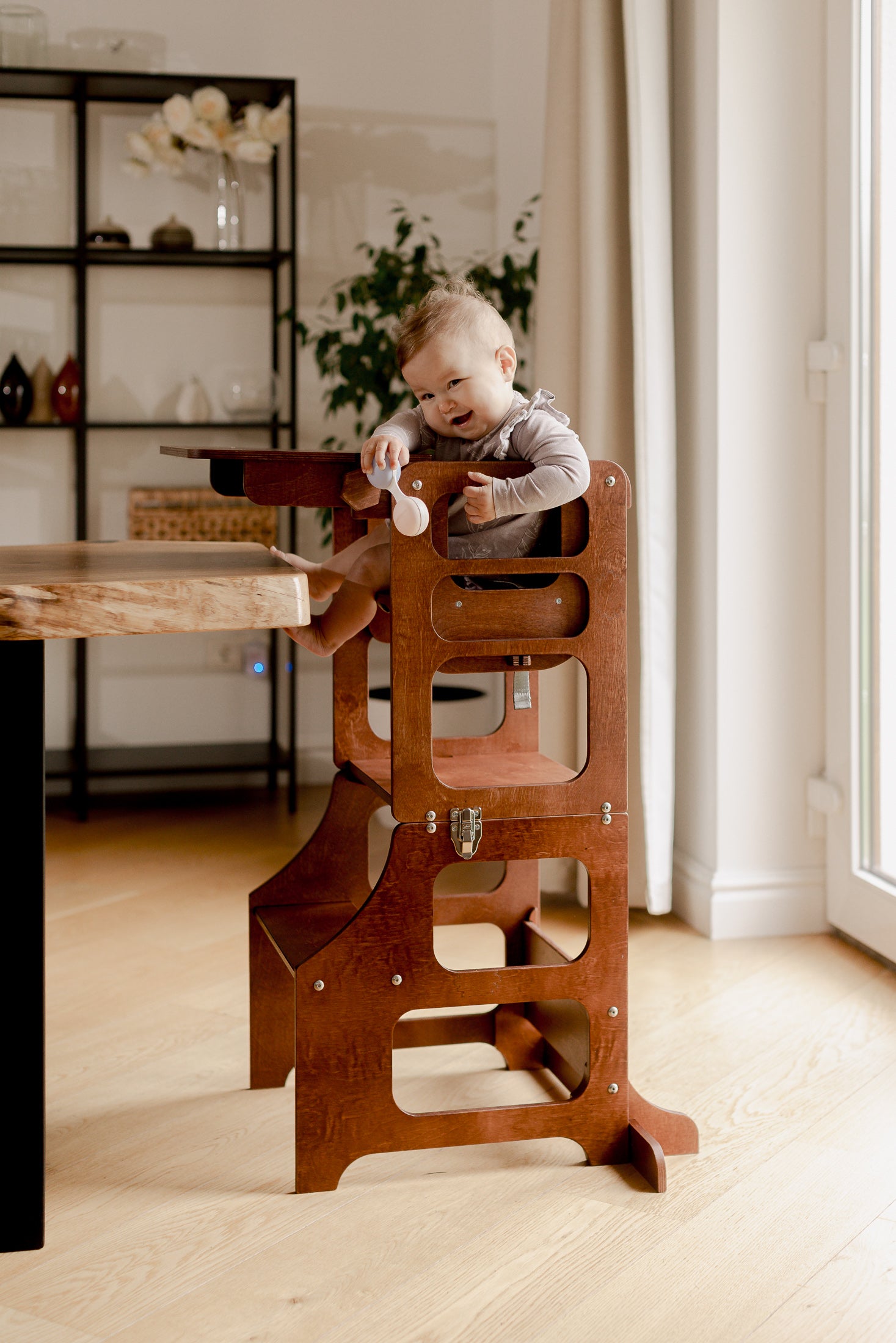 Toddler playing in a Mid Century Modern Foldable Kitchen Tower with a High Chair for a Toddler